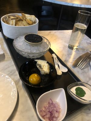 'Caviar' service with truffle chips, butter, (tomato) egg yolk, sour cream and red onions.   at 4296 in Canmore