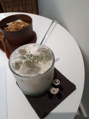 Mugwort latte on a cute panda coaster at LouLou Vegan in Jeju