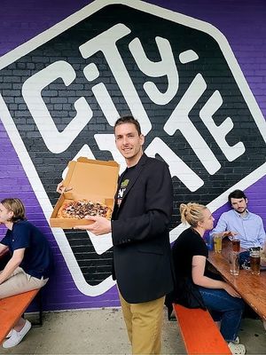 Eating Pizza Loko outside of City State at Pizza Loko in Washington