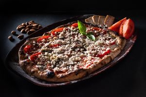 Primavera Peronista: Our version of the classic spring pizza, with slices of fresh tomatoes, basil leaves and homemade almond parmesan.
Pizza primavera, queso de almendras homemade at Layla Restaurant Plants & Mushrooms in Puerto Morelos