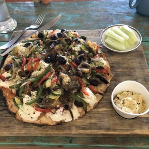 Primavera Pizza with hummus and cucumber   at Layla Restaurant Plants & Mushrooms in Puerto Morelos