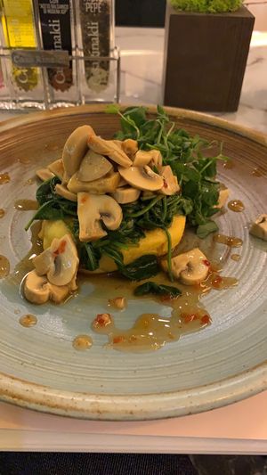 Polenta with spinach and mushrooms 😋  at Organic Life in Chisinau