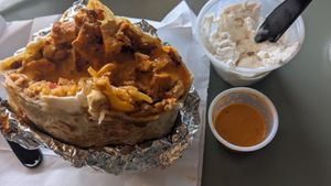Vegan burrito, side of sour cream and medium hot sauce at Habanero Burrito - Food Cart in Portland