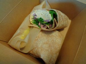 Herbed Hummus Wrap.  housemade roasted garlic + herb hummus, arugula, pickled onion, lemon vinaigrette  at Buckeye Chocolate Café Bainbridge in Auburn