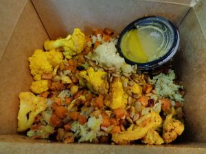 Golden Veggie Bowl. Jasmine rice, turmeric cauliflower, sweet potatoes + parsnips, sunflower seeds, golden shallot vinaigrette at Buckeye Chocolate Café Bainbridge in Auburn