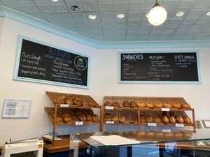 Bread displayed under signs about their offerings at Allegro Bakery in Pittsburgh