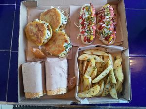 Combo: papas gajo, baguette de milanesa, jochos con salchicha de seitan, gorditas de chicharrón  at Coral Restaurante in Cozumel