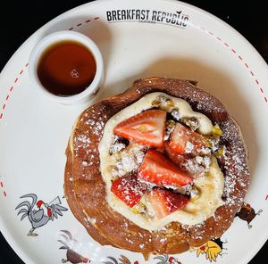 Vegan Tres Leche Pancakes: Vanilla pancakes, vegan sweet buttercream, almond, coconut, and oat milk syrup, and fresh strawberries topped with pistachio brittle. Insanely good!   at Breakfast Republic in Costa Mesa