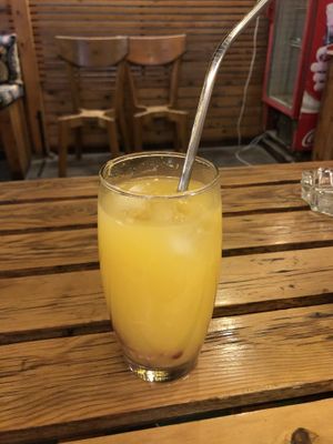 Orange juice with a metal straw at Box Meal in Dahab