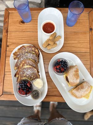 Classic French Toast, Mozzarella sticks and the Farmer John Breakfast Sandwich— all delicious!  at Brunch Bird in Austin