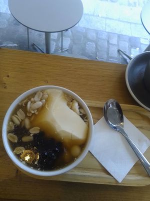 fleur de tofu with silken tofu, cashews, adzuki beans, and tapioca pearls (served warm with ginger syrup) at Graines du Jour in Paris