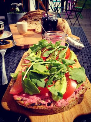 Rainbow open sandwich with beetroot hummus, tomatoes, avocado and rocket salad at Orðakaffi in Akureyri