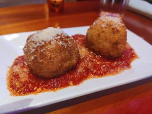 Fried mac and cheese balls with marinara sauce and vegan parmesan at Monster Vegan in Philadelphia