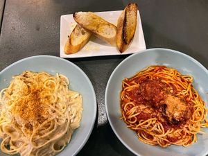 Clams with linguine, spaghetti with meatballs & garlic bread.  at Monster Vegan in Philadelphia