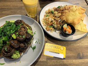 Smashed avo with cooked spinach and mushrooms; and the vegan nasi goreng; with freshly squeezed OJ at KOPIKU in Oconnor