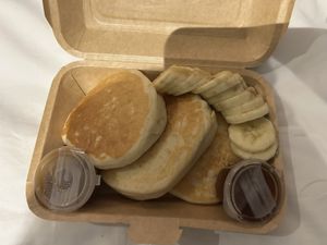 Delicious pancakes with salted caramel sauce and banana  at Carrots The Vegan Kitchen in Bangkok