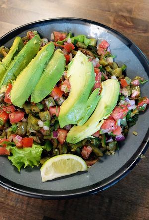 Bowl with herb rice, greens, avocado, cactus, black beans, pico, and cilantro. at Comālli Taqueria in Reading