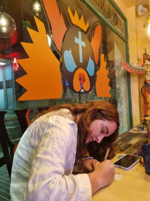 Writing a message for deceased dear one for the altar at Chiwawa Cantina in Gran Canaria