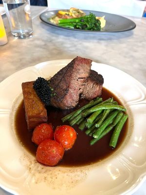 Grilled Chunk Steak Filet | Black peppercorn cream sauce, potato pavé, haricot verts, balsamic caviar, chives, roasted cherry tomatoes at Willow Vegan Bistro in New York City
