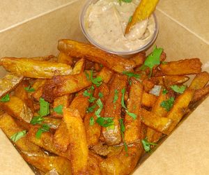 house-cut double-fried crispy fries with homemade black garlic aioli (v) (df) (ve option) at Taco Rio in Harrison Hot Springs