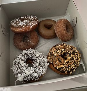 French toast, maple pancake, apple cider, chocolate coconut, and snickers  at Donut Run in Washington