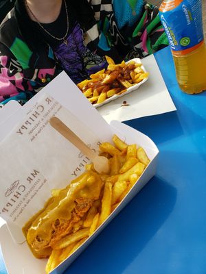 Vegan sausage and chips with curry sauce. (And vegan chips n gravy behind) at Mr Chippy in York