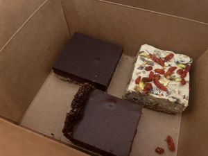 Millionaire shortbread, white chocolate, fig and walnut square with goji berries and my fave hazelnut and chocolate tart  at The Conscious Kitchen - Kloof St in Cape Town