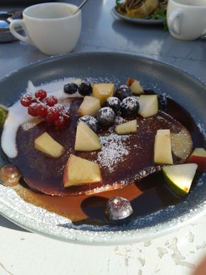 a "dutch baby" is a crossover between a pancake and a soufflé: quite eggy/chewy, covered with a sweet sauce and served with fresh fruits at Superkelly in Ghent