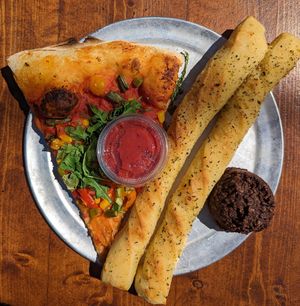 Spring Fever pizza, garlic breadsticks with pizza sauce, and Chocolate Coconut Ball at Mississippi Pizza in Portland