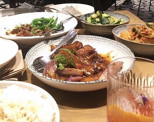 Glazed chilli eggplant with black pepper tofu (left) and kimchi and cucumber salad (right). at east in Auckland