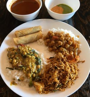Some lunch buffet vegan items recommended by the host. Plate from top left: Spring Rolls, Channa Masala, Vegetable Biryani, Dal. Bowls from top left: Rasam Soup, Onion/Mint Chutney at Kumar's Minneapolis in Apple Valley