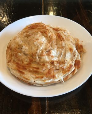 Side of Oor Style Parota. A pair of flaky, layered, southern style bread. at Kumar's Minneapolis in Apple Valley