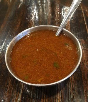 Melagu Rasam Appetizer. Tomato based tangy soup with ground black pepper. Loved it. at Kumar's Minneapolis in Apple Valley