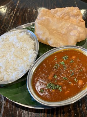 Pondu Puli Kolambu & side of Poori bread. Vegetarian & diary free. A tangy curry made with tamarind & about 15 roasted garlic cloves - amazingly flavorful & not too garlicky! at Kumar's Minneapolis in Apple Valley