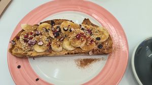 Banana with peanutbutter hemp seeds maple syrup and cinnamon so yum! at Pink Neon Sign in Auckland