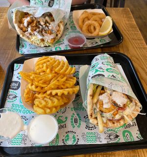 Chick*n gyros, fully loaded and drizzled with garlic mayo. A side of waffle fries and onion rings. We also got baklava, but forgot to take a pic, ask for no choc sauce! at What The Pitta in Manchester