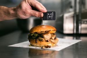 The Hogless Roll - 48-hour marinated soy protein, infused with smoky BBQ flavours, topped with our homemade pea and sage stuffing, chunky apple sauce and our secret vegan crackling at The Hogless Roast in East London