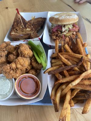 Platter of yumminess- Reuben, bbq sandwich, spicy seasoned fries and cauliflower wings at Beaut Burger in Phoenix