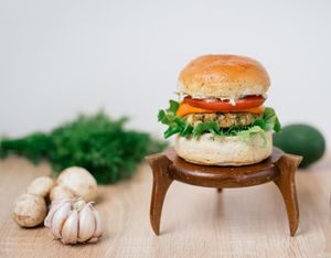 Vegan burger with a chickpeas patty, homemade brioche bun, vegan tzatziki, tomato, homemade cheddar sauce, tomato, green salad.  at New Wave Burgers in Sofia