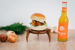 Vegan burger with homemade brioche bun, jackfruit with homemade barbeque sauce, onion and parsley, homemade vegan mayonnaise, pickles, homemade cheddar sauce, green salad. at New Wave Burgers in Sofia
