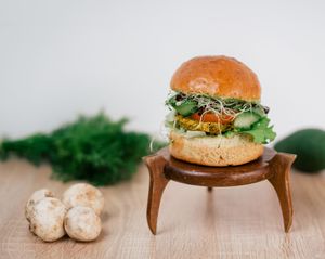 Vegan burger with a mung bean patty, homemade brioche bun, homemade avocado mayo, cucumber, tomato, sprouts, green salad.  at New Wave Burgers in Sofia