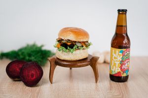 Vegan burger with a beetroot/mushroom patty, homemade brioche bun, homemade barbeque sauce, homemade cheddar sauce, pickles, green salad.  at New Wave Burgers in Sofia