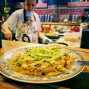 Cock potato pancake: potato/squash/pumpkin pancake fried in coconut oil, covered with “Cock's nest” salad: soy meat, lightly salted cucumber, tofu, onion, garlic ceasar at Bumpkin Veg Cafe in Novosibirsk