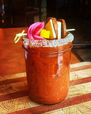 Smoky Bloody Mary garnished with housemade vegan salami and smoked Gouda! at Basecamp in Durango