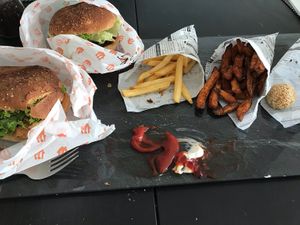 Tofu burger (left), blackbean burger (rear), super crunchy fries, sweet potato fries, and sweet sesame balls at Kenkō Burger in Leipzig