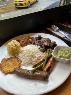 rice, portobello and grilled vegetables, plátano spider with guacamole, house chorizo and chicharrón  at Veggie Beans and Shakes in Bogota