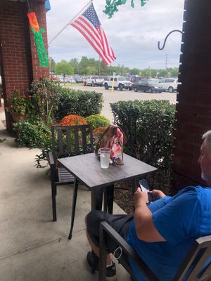 Very cozy seating outside with pretty foliage - felt like I was in a garden! at Seaside Bagels in Wilmington