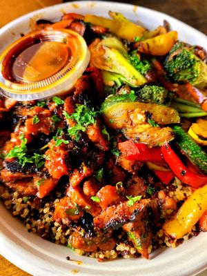 Quinoa bowl with BBQ carnitas and orange sauce at Roasted and Raw in Oakland