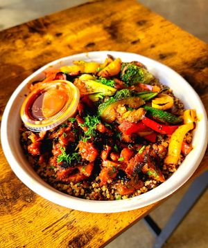Quinoa bowl with BBQ carnitas and orange sauce at Roasted and Raw in Oakland
