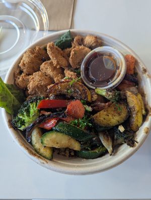 Orange teriyaki bowl with chik'n on a bed of greens and quinoa at Roasted and Raw in Oakland